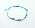 Pulsera de piedras naturales turquesa y coral con baño de oro amarillo